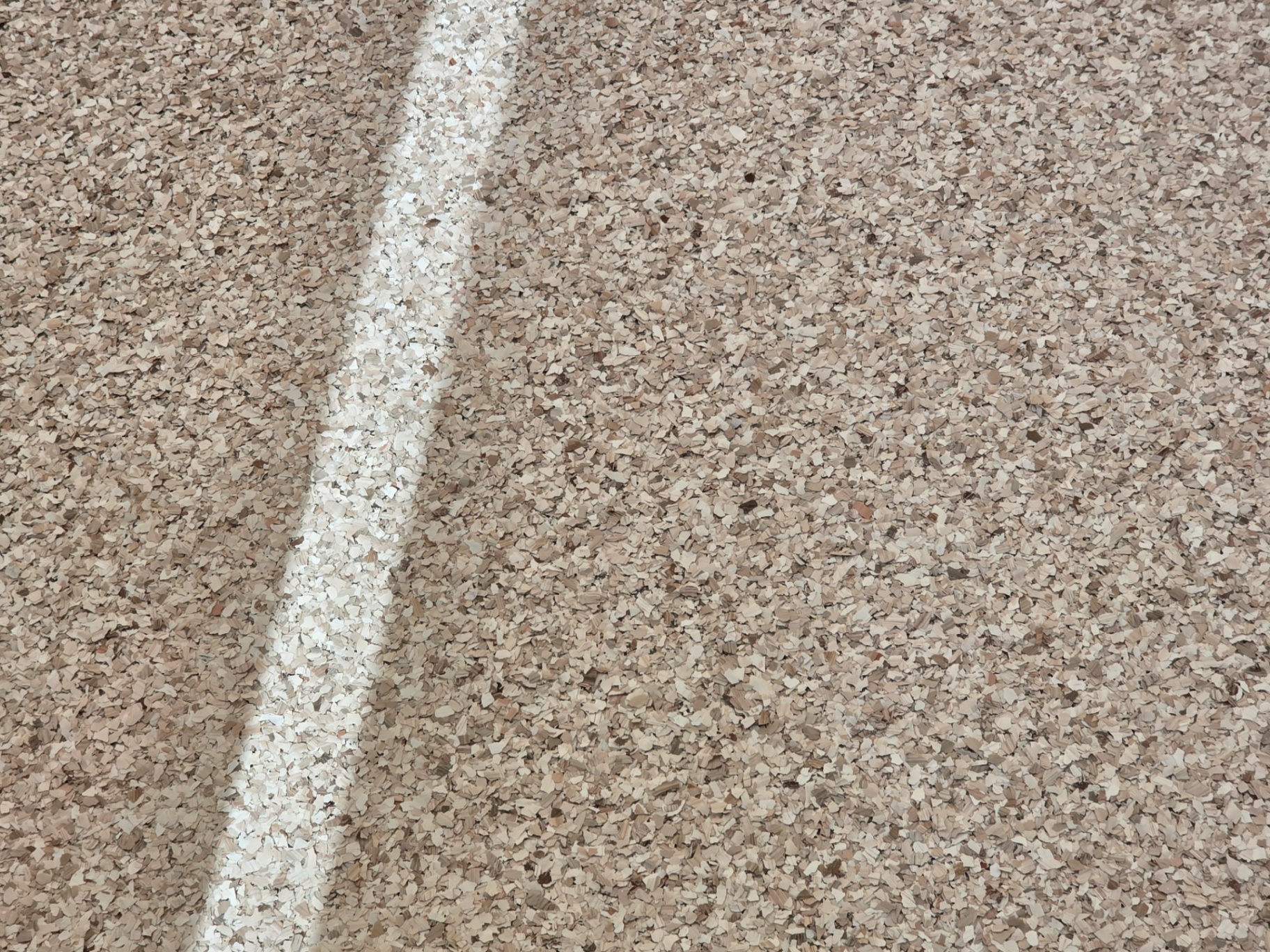 Tan epoxy flake floor close-up texture