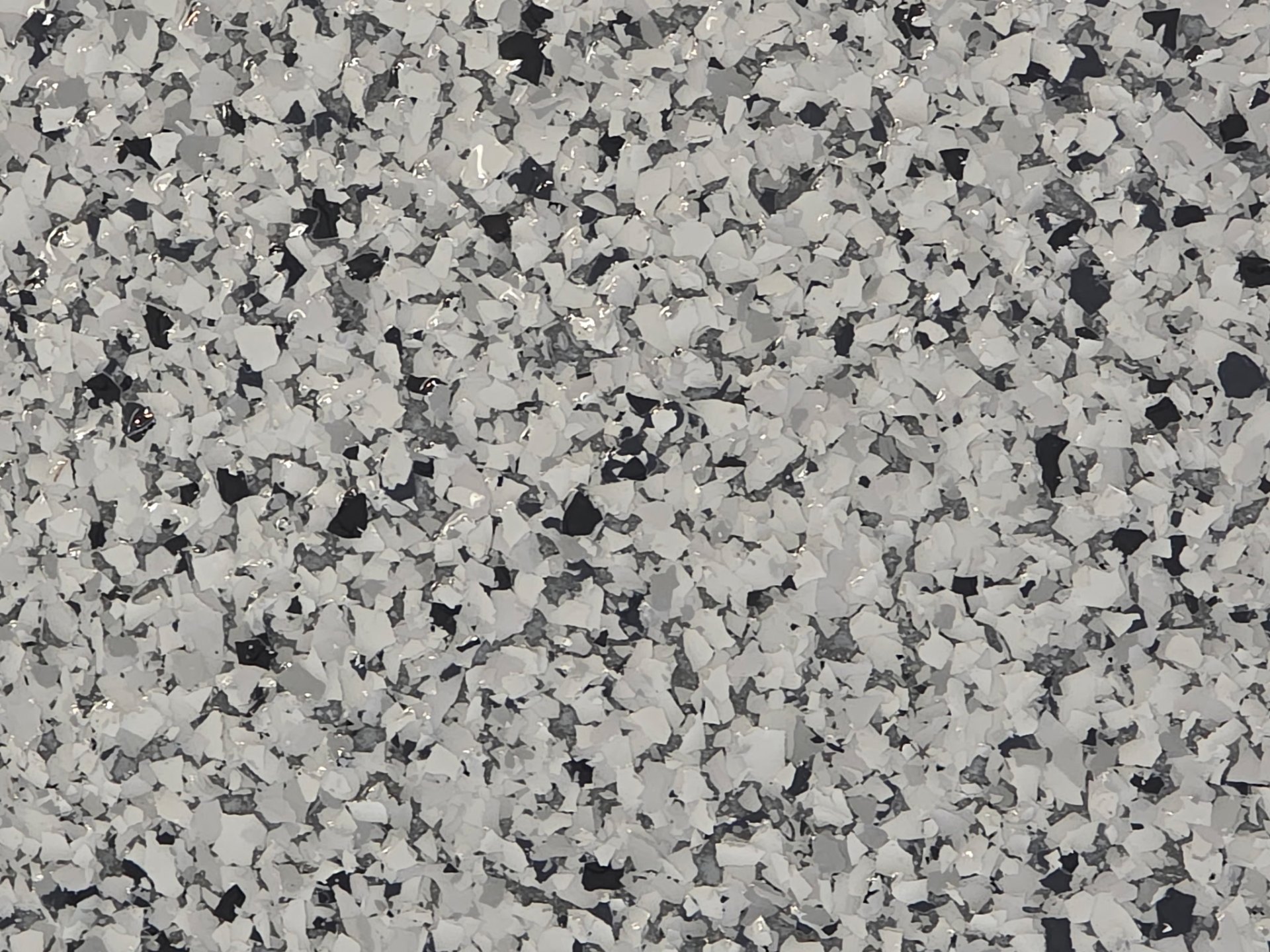 Close up of gray epoxy flake floor texture in a Washington garage